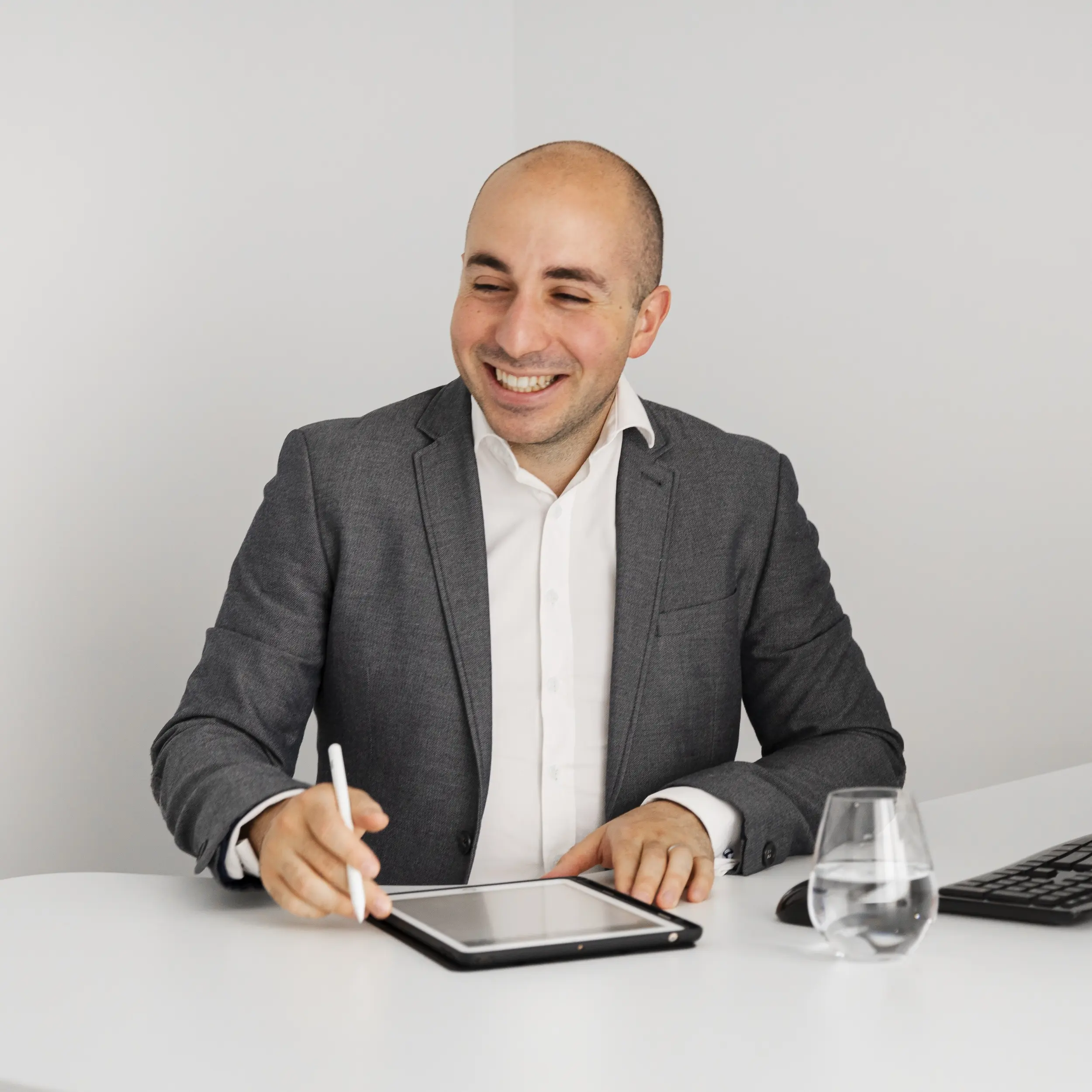 Robert daniele laughing at his desk.