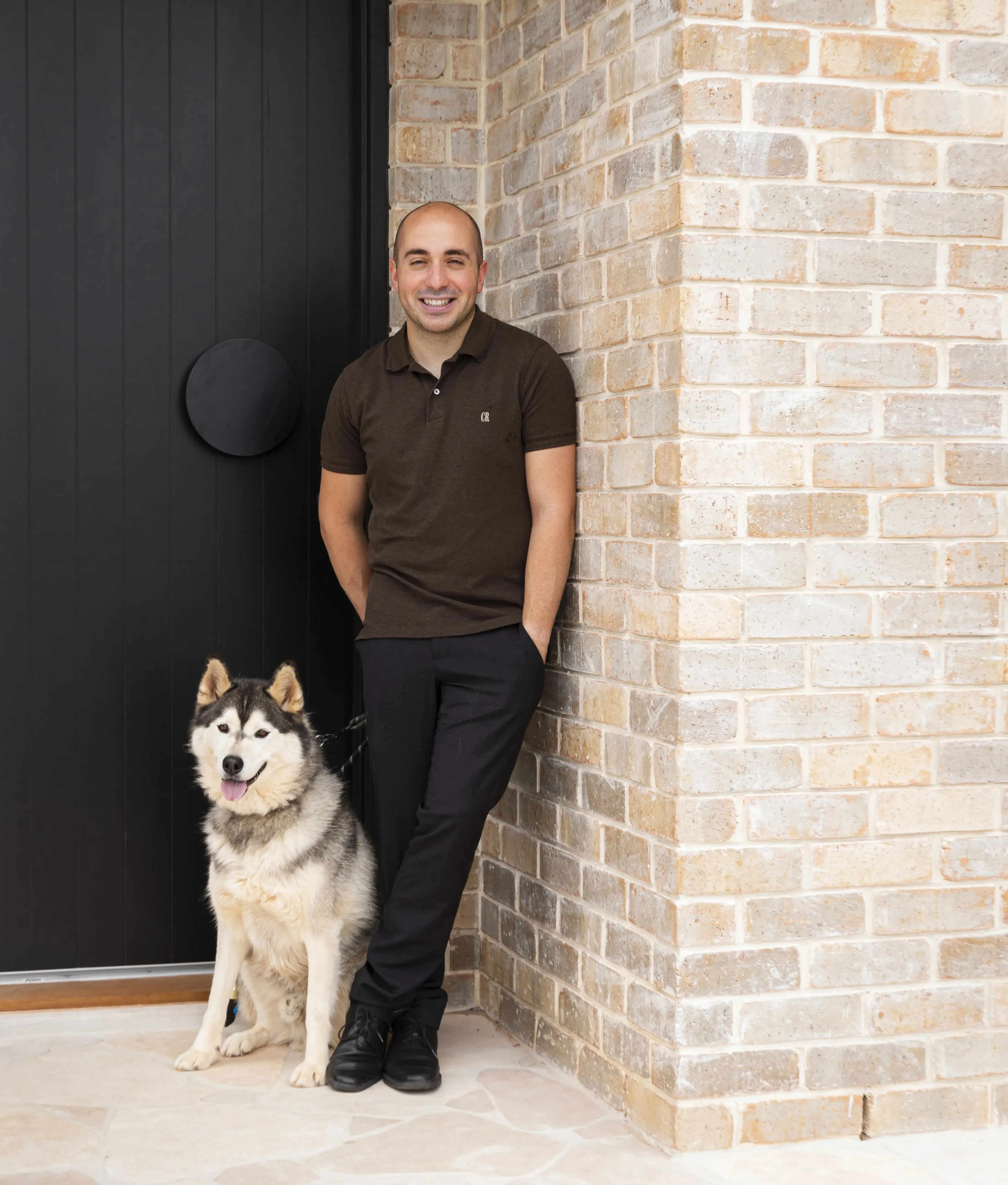 Robert Daniele in a t-shirt with his dog.
